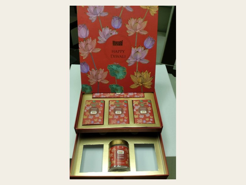 Printed hamper box with fitted cavities holding jars and tins